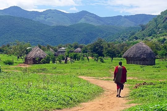 Masai man and village