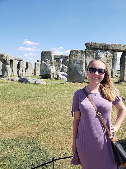 Image may contain: Susan Arnold, smiling, standing, sky, grass, cloud, outdoor and nature