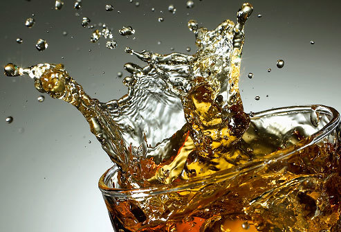 Ice splashing into diet soda cocktail