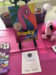 Franky the Finicky Flamingo book displayed on pink tablecloth with several pink flamingos