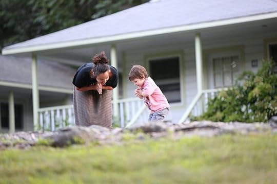 Woman and child hands together outside