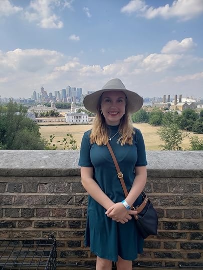 Image may contain: 1 person, smiling, standing, cloud, sky, hat, outdoor and nature