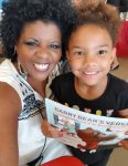 Florenza pictured with girl holding Barry Bear's Very Best book that Florenza authored