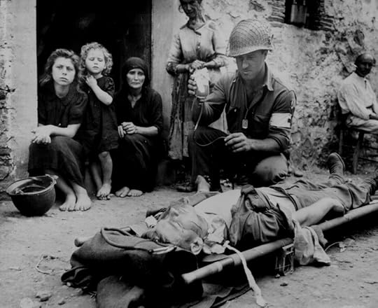 US Army PFC Harvey White administering plasma to wounded Private Roy Humphrey, Sant’Agata, Sicily Italy, 9 Aug 1943 (US National Archives)