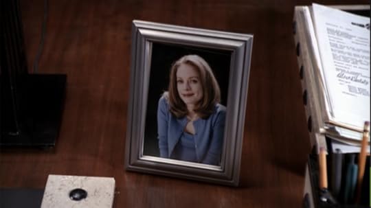 Melissa is wearing a blue cardigan/sweater combo that she's wearing in the scene she's in right before this.