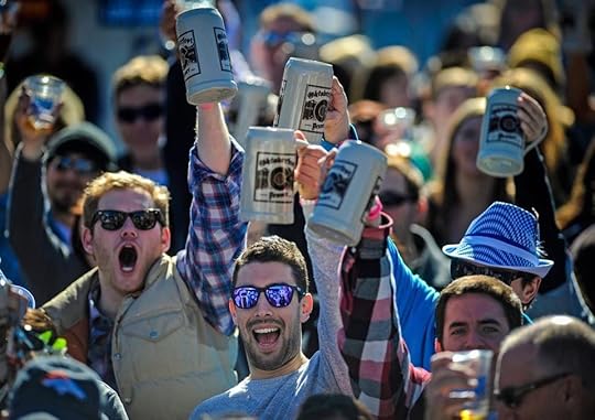 Men holding up beer mugs at Oktoberfest in Denver, Colorado