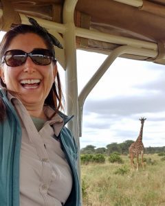 Lisa Niver in Tanzania with a giraffe