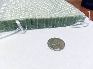 3d Woven fabric next to a US Quarter coin