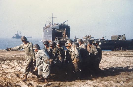 With USS LST-1 in the background, US Army Engineers haul a roll of wire mesh to make a beach roadway, Salerno, Italy, September 1943 (US National Archives)