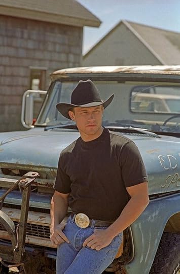 cowboy leaning against the truck