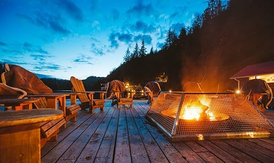 Patio seating with fire at Nimmo Bay Wilderness Resort