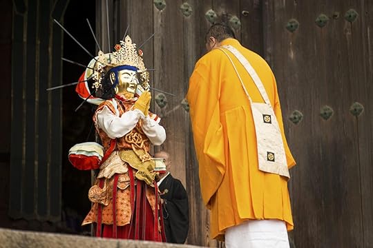 Man and praying statue in Japan