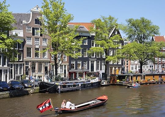 Boat floating down a canal in Amsterdam