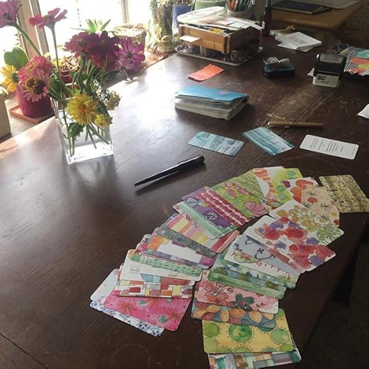 My studio desk today: lovely flower coworkers from my garden, notebook, letters to students, and a sample of my new project: the Major Mojo Card Deck!