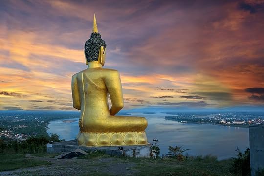 Big buddha over the city on river in twilight in Laos