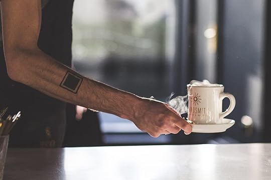 Barista serving cup of coffee at the Grindsmith coffee shop in Manchester