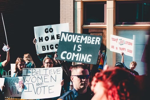 People Holding Banner Near Building