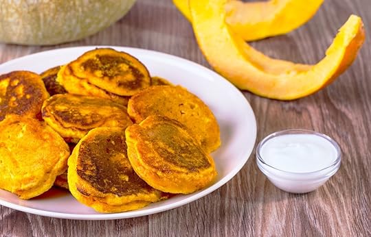 pumpkin pancakes on a plate with dipping sauce