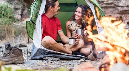 couple camping in rock mountains with their dog