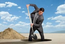 man digging a hole in the desert