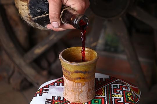 Homemade Moldovan wine pouring from a traditional homemade bottle