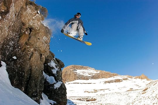 A snowboarder jumps off a cliff in rural Lesotho