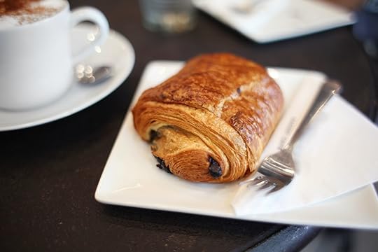 Chocolate croissant and cappuccino on a table