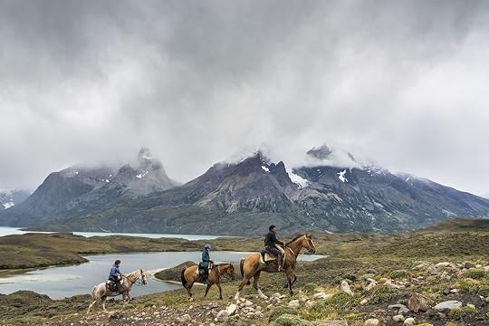 Gaucho with group of tourists riding horses Torres del Paine National Park