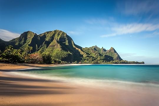 Hawaiian paradise with tall mountains, turquoise sea and white sand on Kauai
