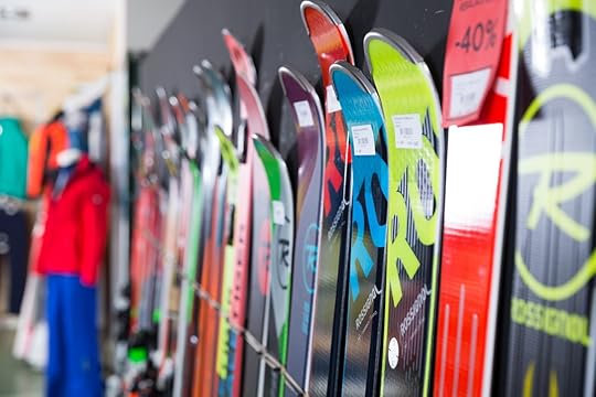 Sport goods store interior with large choice of modern skis