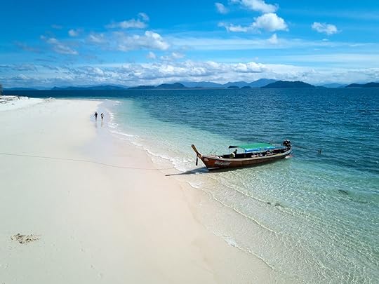 A traditional Thai longtail boat anchored on Koh Khang Khao island near Koh Phayam
