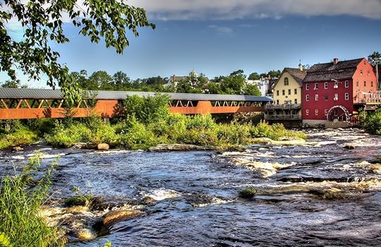 The River Walk Covered Bridge with the Grist mill on the Ammnosuoc River in Littleton New Hampshire