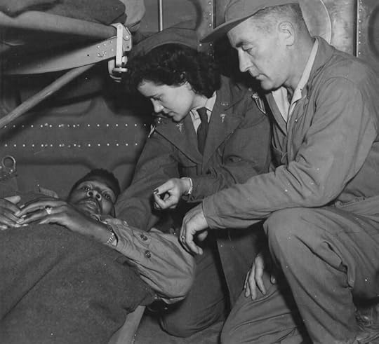 Lt. Pauline Curry & Tech. Sgt. Lewis Marker, 803rd MAETS, check a patient on a flight over India (US Air Force photo)