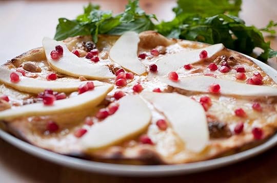 Turkish pizza topped with cheese and pomegranate seeds