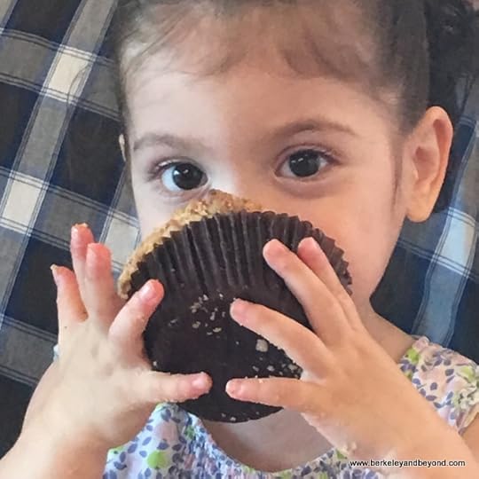 child smushes a muffin into her face at Bakery Lorraine in the Pearl in San Antonio, Texas