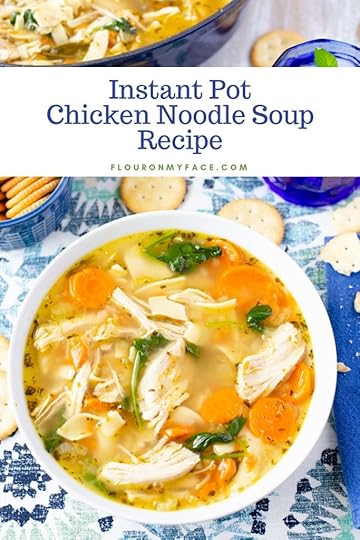 IA bowl of nstant Pot Chicken Noodle Soup recipe served in a white bowl, on a blue place mat with a navy blue napkin. Served with crackers.