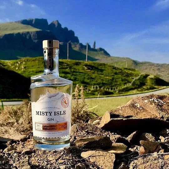 Isle Of Skye Distillers Misty Isle Gin bottle in front of a Scottish landscape