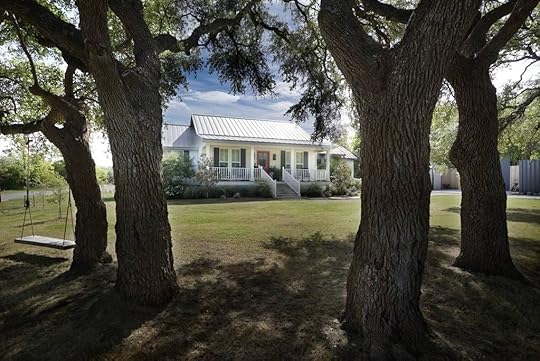 Fixer Upper house from the outside, view between trees