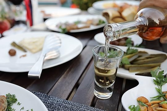 Waiter pouring chacha into glasses in cafe