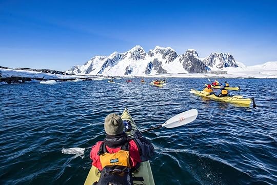 People paddling in waters of Pleneau Island, Antarctica