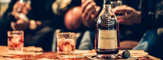 Bottle of Hennessy with two glasses