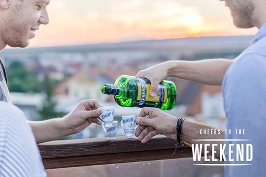 Friends pouring Becherovka Original in front of a cityscape