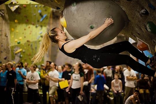 Rock climber on a wall at a climbing gym