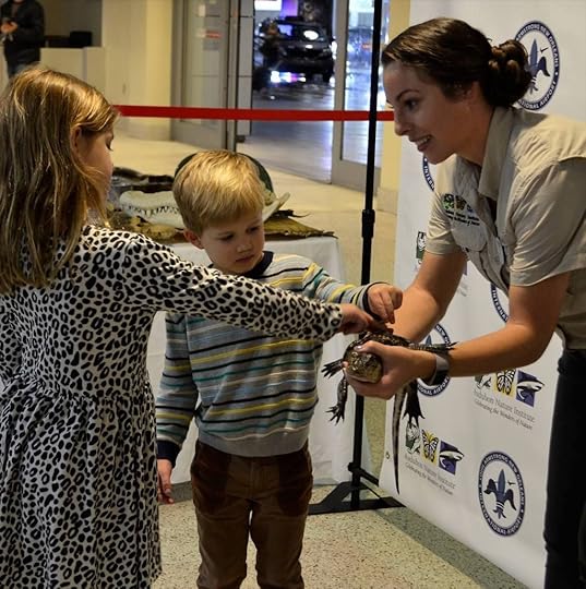 Kids petting a baby alligator at New Orleans airport