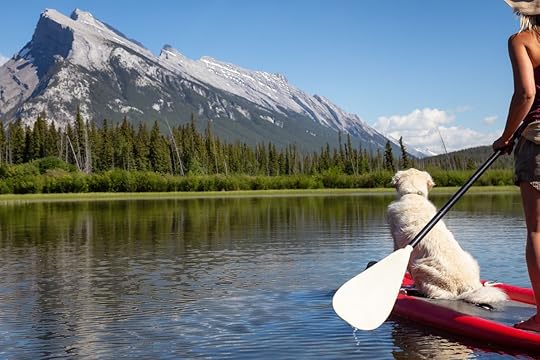 Woman on a paddle board with her dog in Banff, Canada