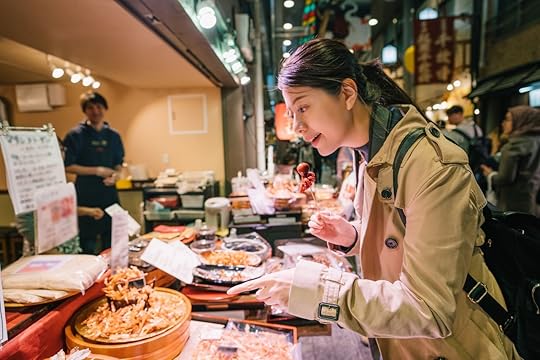 Woman tourist standing in front of the vendor in the market in Japan