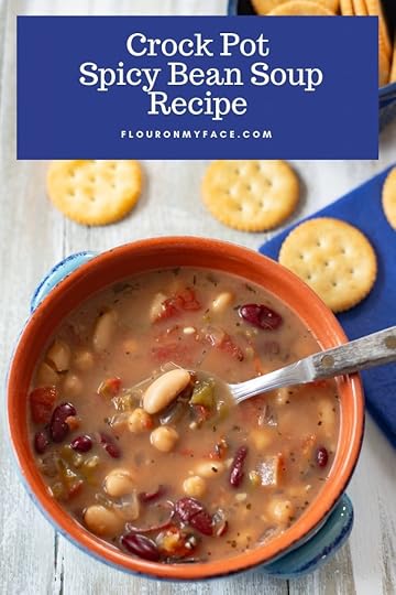 Crock Pot Spicy Bean Soup served in a blue terra cotta bowl with crackers.