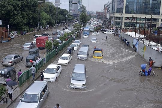Vehicles trying to drive through a flooded street in Dhaka