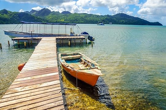Orange boat and pier with view of San Andres y Providencia, Colombia in the background