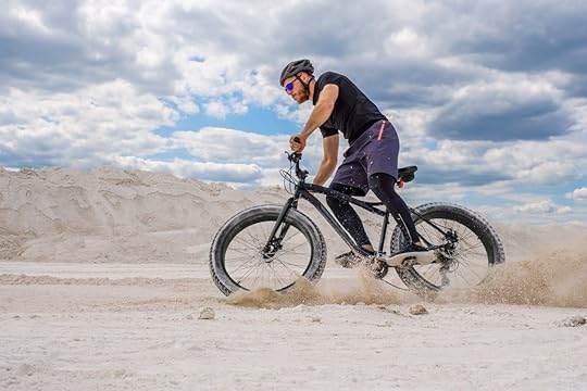 Man riding a fat bike in the sand